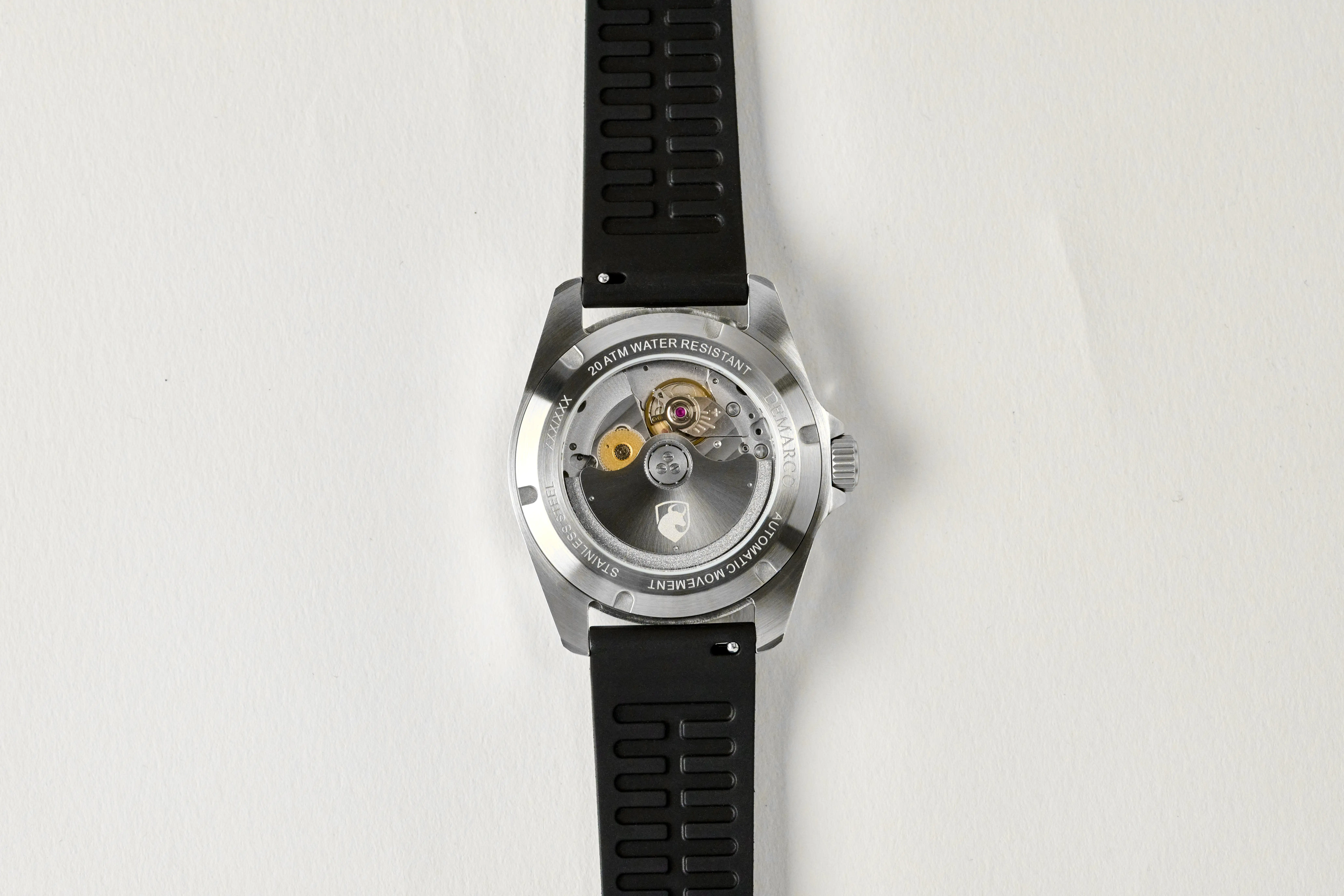 The Miyota 9015 movement seen through the sapphire display caseback of the DeMarco Ironside 200, on a black FKM rubber strap