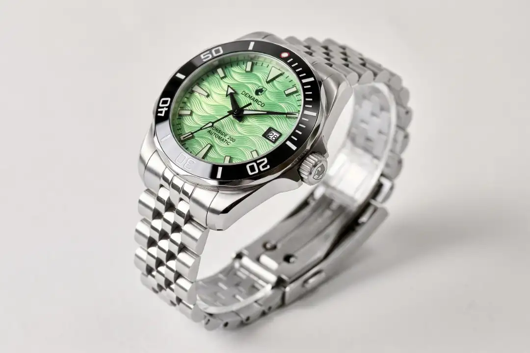 The DeMarco Ironside 200 with a green wave dial and black bezel on a steel jubilee bracelet