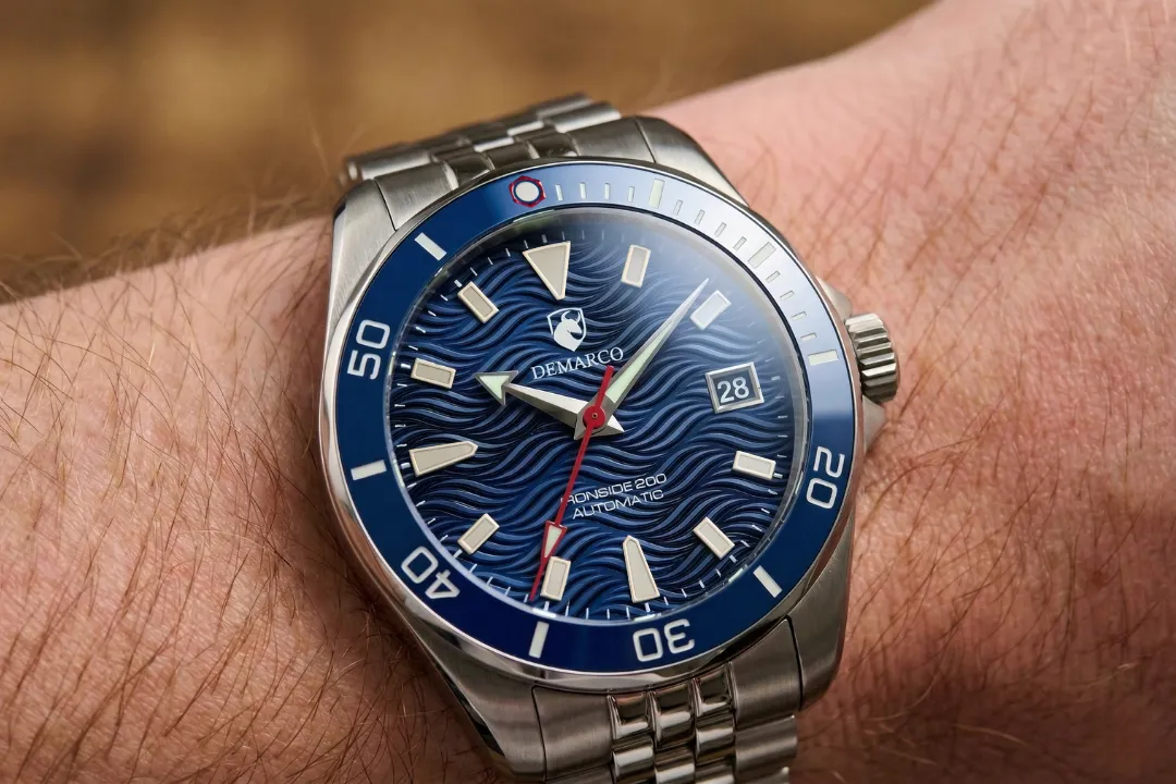 The DeMarco Ironside 200 with a blue wave dial and blue bezel, worn on the wrist