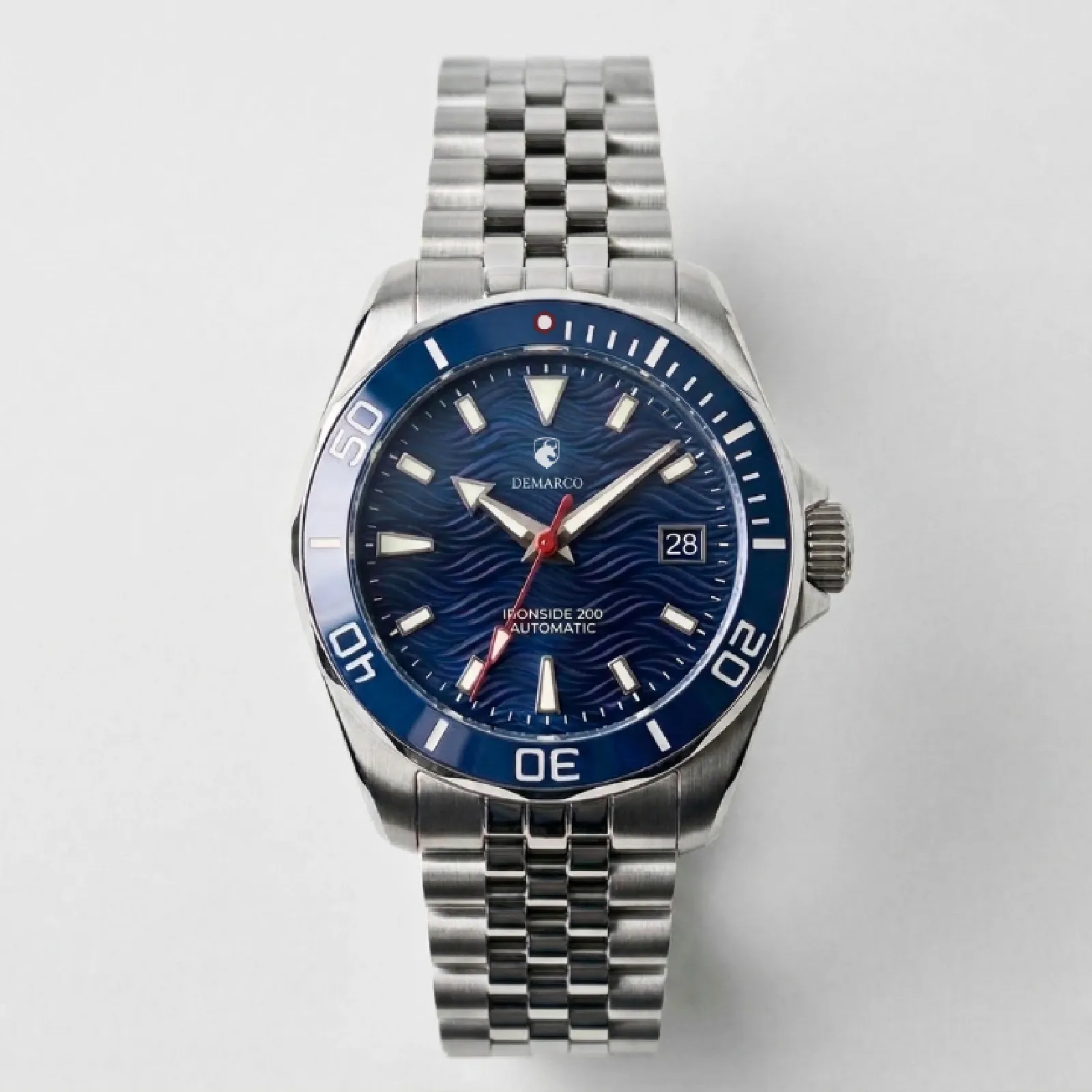 The DeMarco Ironside 200 with a blue dial and blue bezel on a steel jubilee bracelet, on a white background