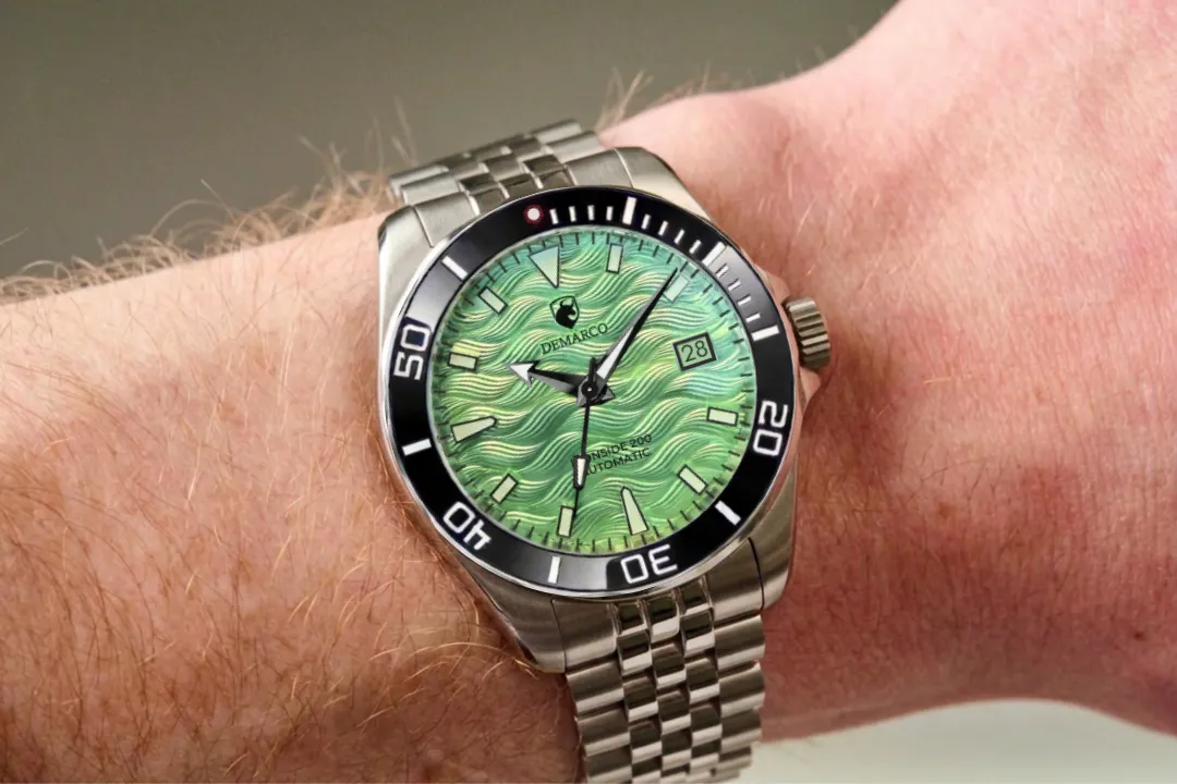 The DeMarco Ironside 200 with a green wave dial and black bezel, worn on the wrist
