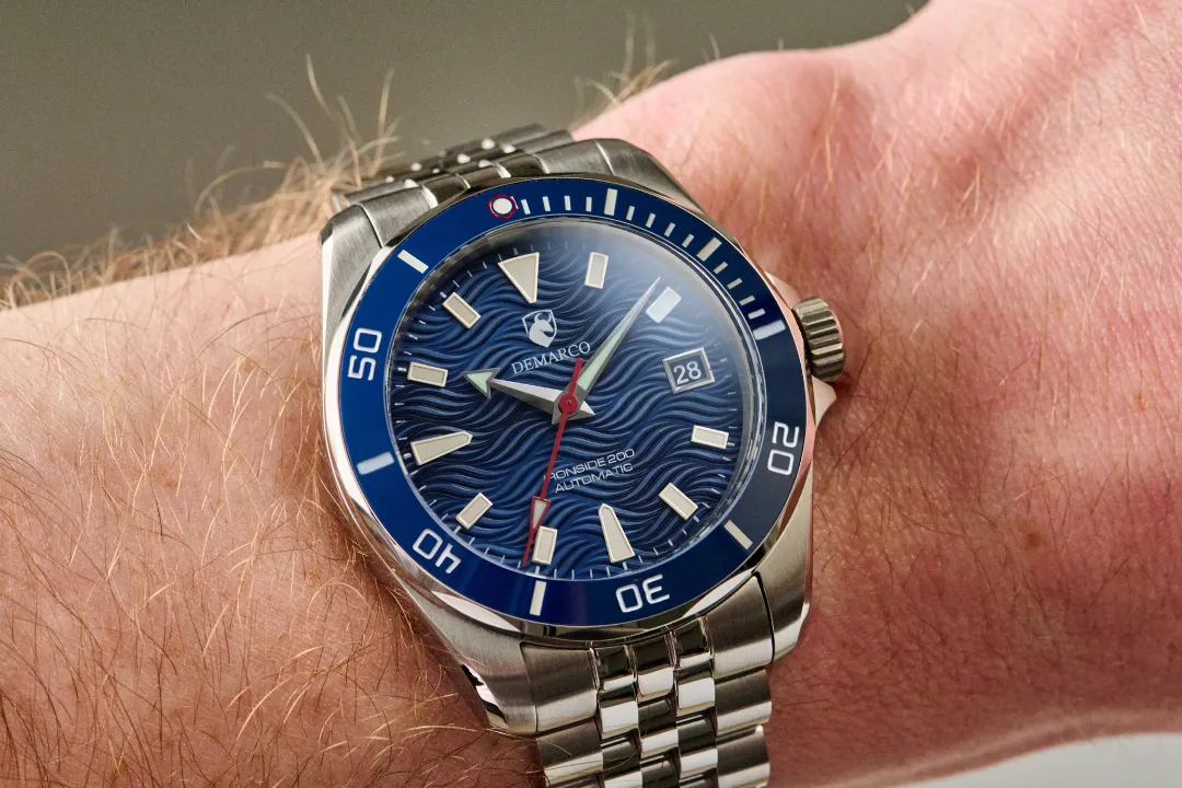 The Ironside 200 Harbor Blue worn on a wrist, with the blue ceramic dive bezel and its lume pip at twelve o clock clearly visible