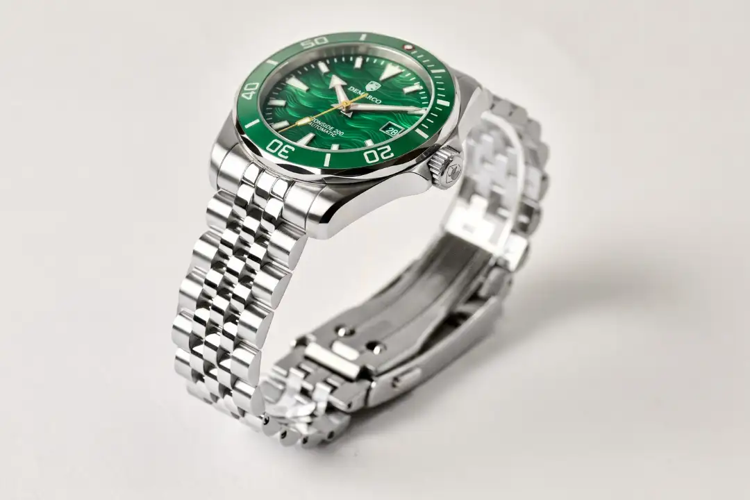 The Ironside 200 Essex Green at an angle, showing the lume filled hands and hour markers against the green wave dial