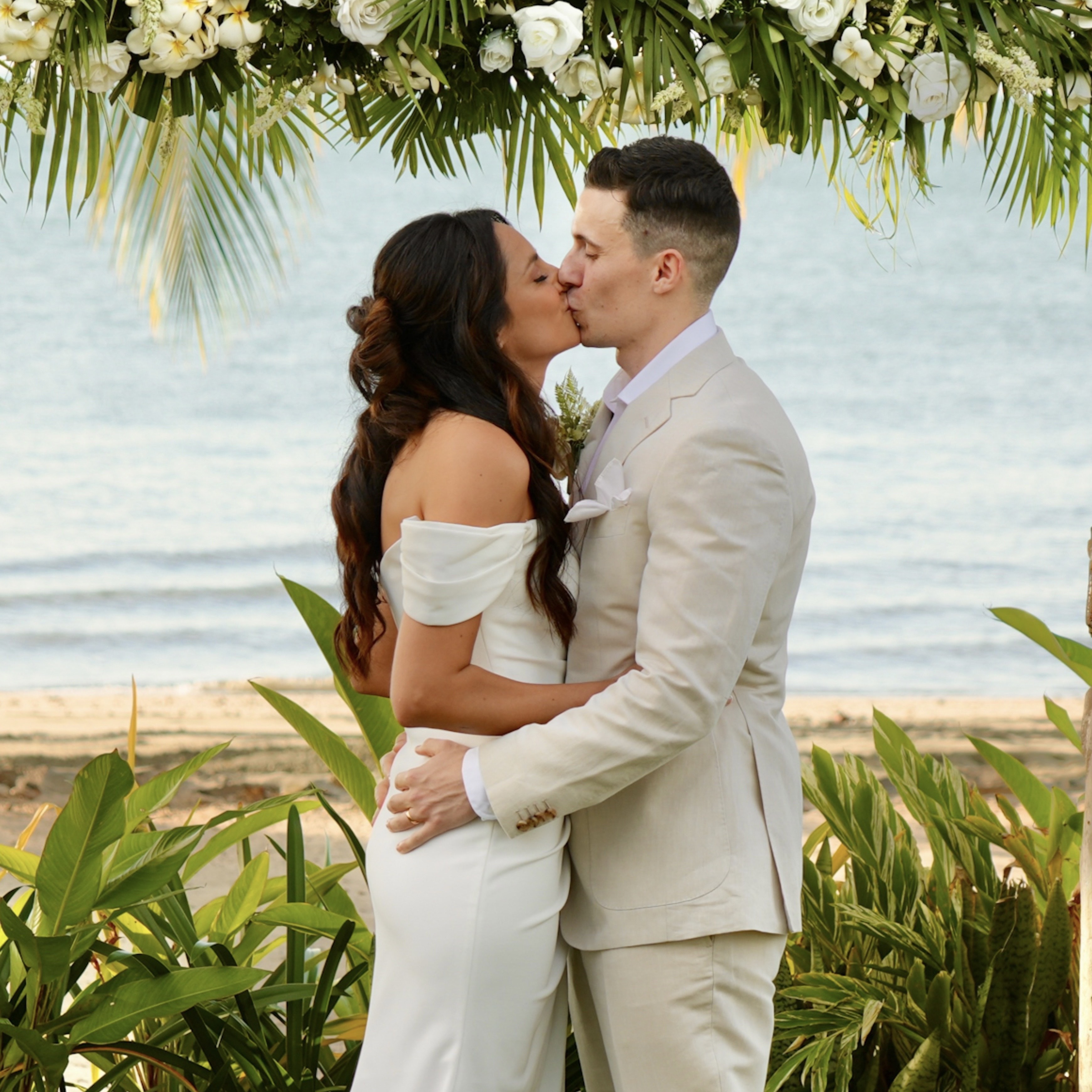 Man adjusting bride's dress. 