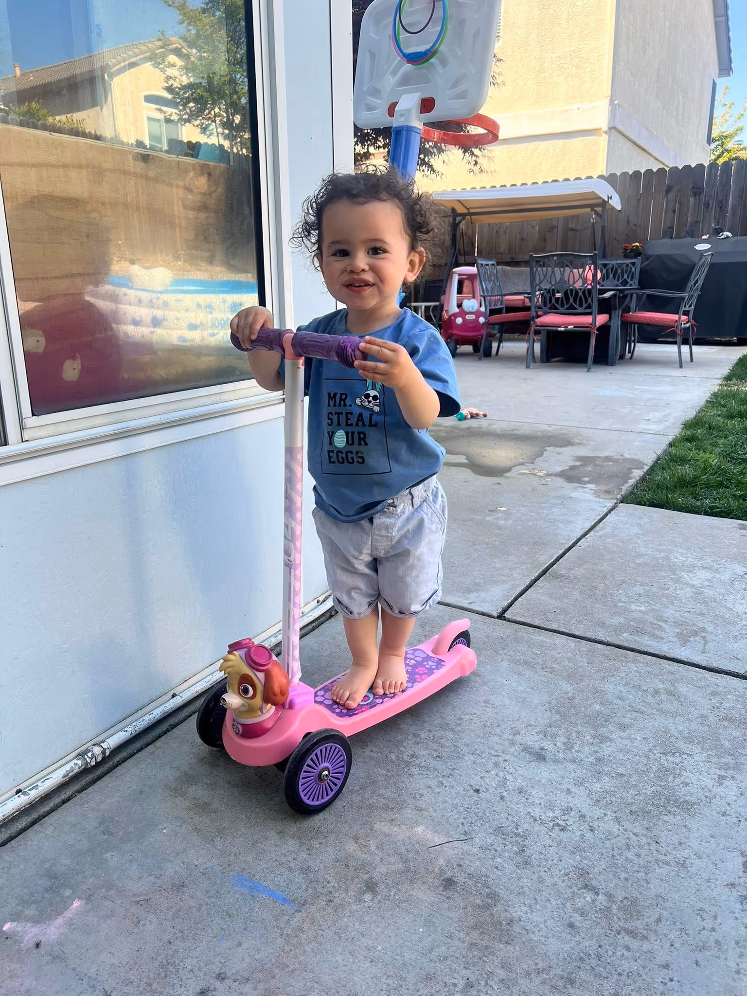 A boy on a three-wheel scooter