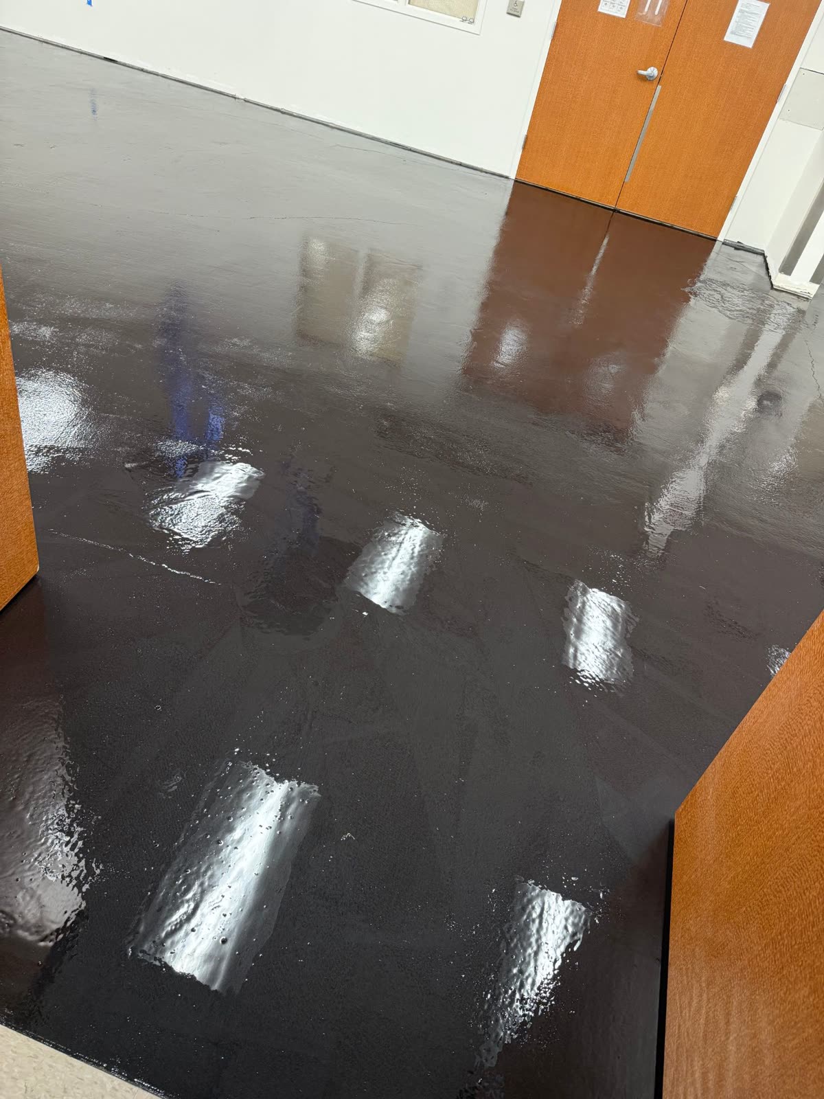 Moisture mitigation membrane applied over a prepared concrete slab
