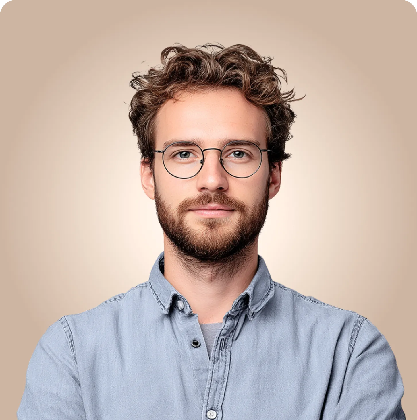 Portrait of man with curly hair and glasses against beige background.