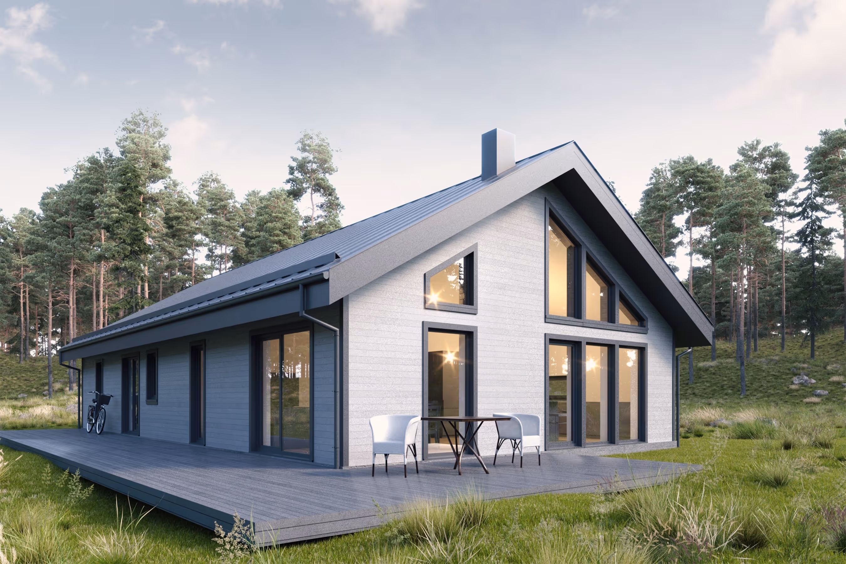 Modern grey wooden house with large triangular windows and a patio with two chairs and a table, surrounded by grass and trees.