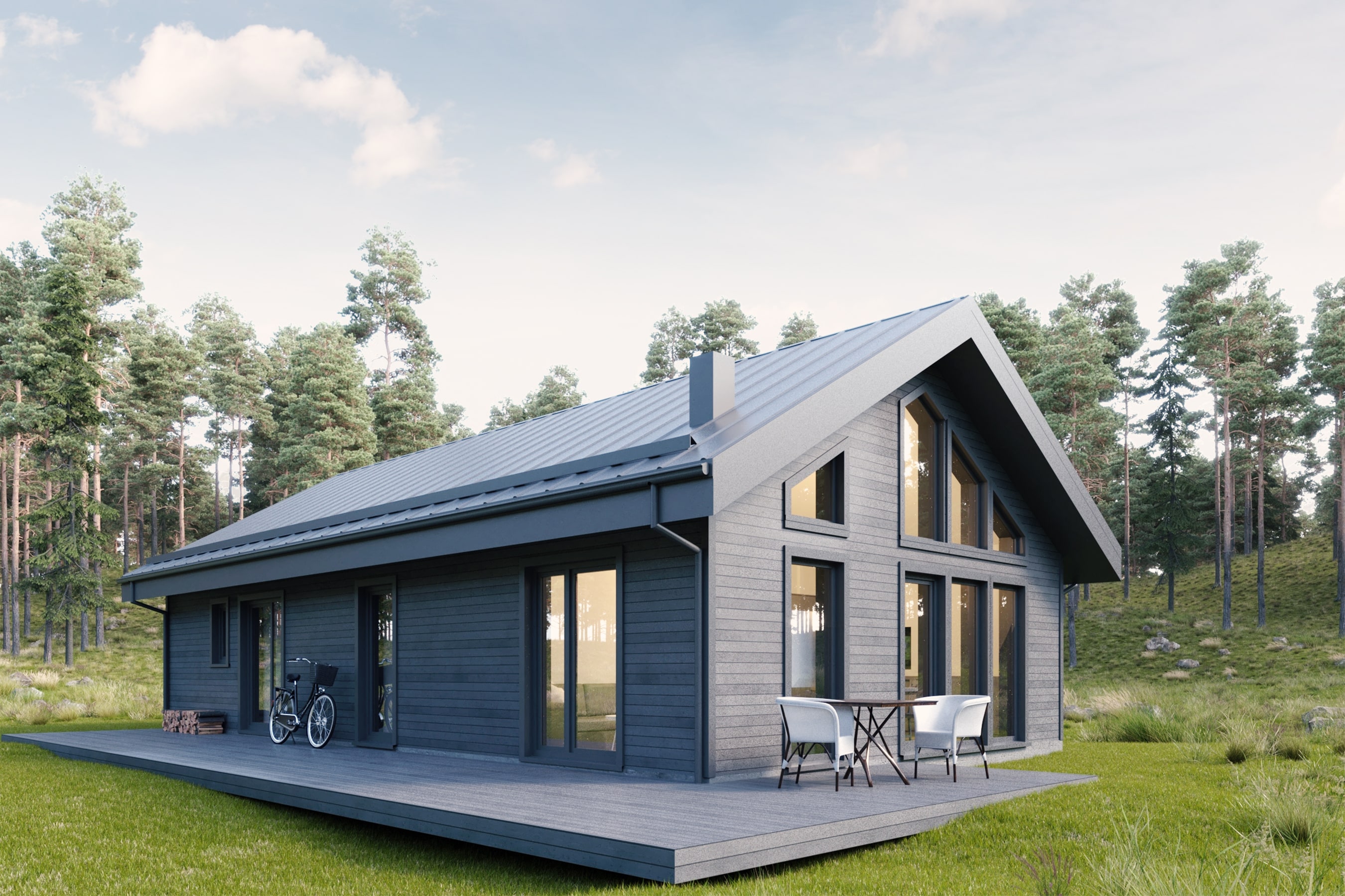Modern gray wooden house with large windows, metal roof, outdoor patio with table and chairs, and a bicycle, surrounded by green grass and pine trees.