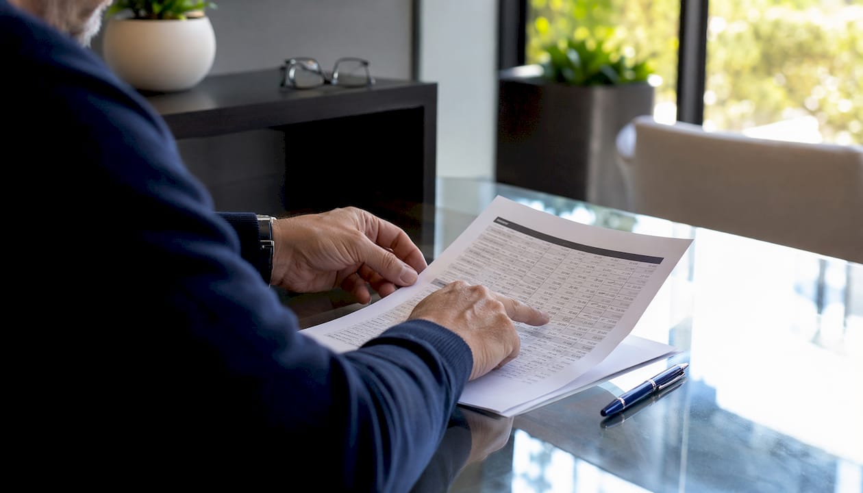 Hands reviewing mortgage amortization schedule