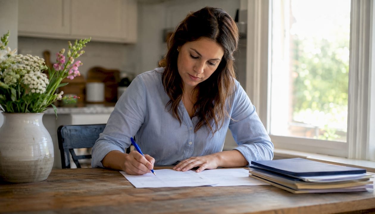 Hands completing homestead exemption application form
