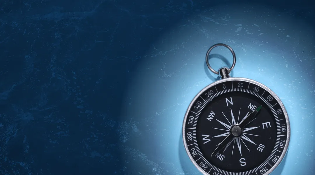 Nautical compass on blue background