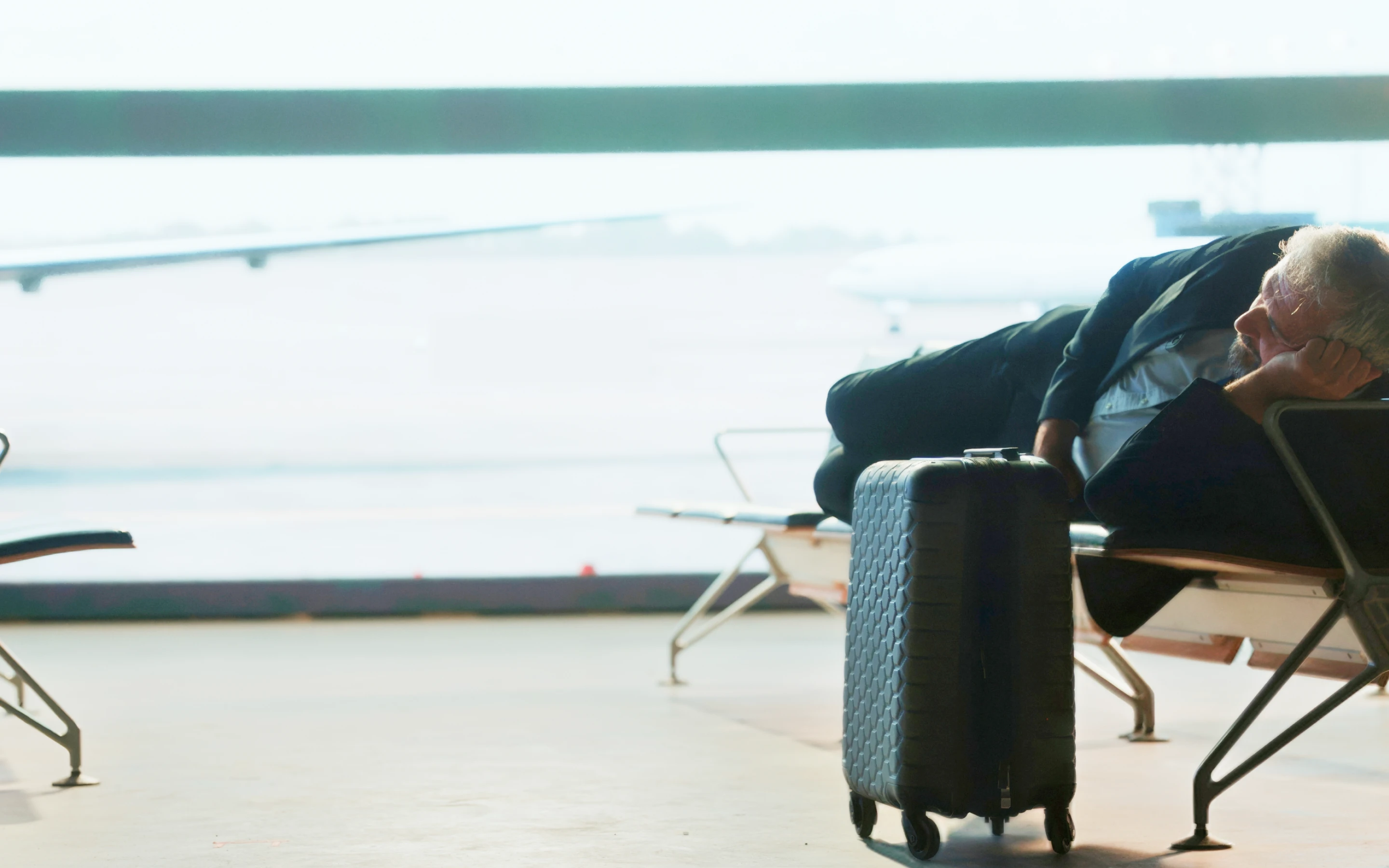 TrvlWell - man resting in airport