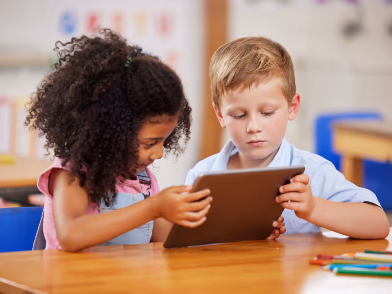 Image showing children in a classroom, using a tablet running Bento MDM software