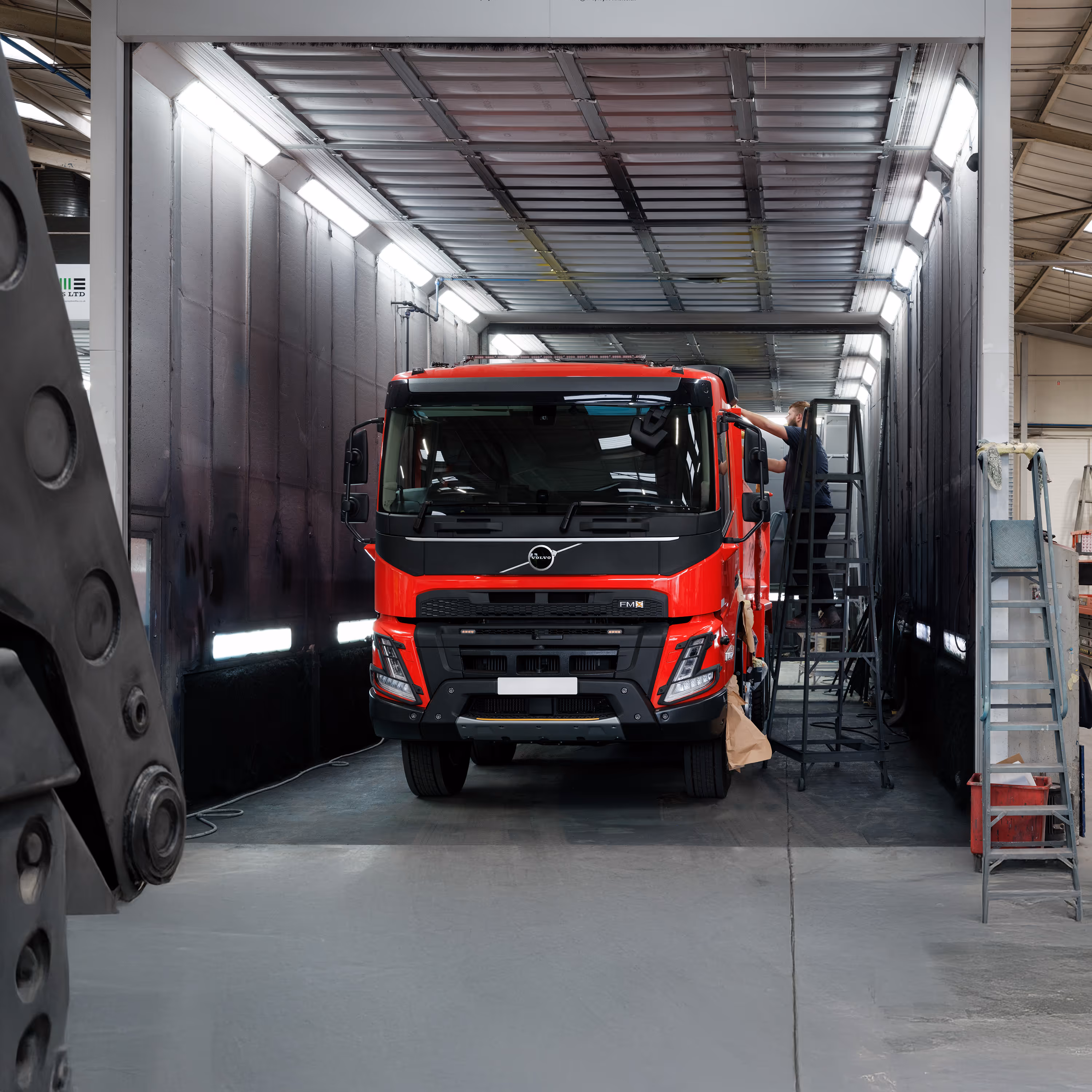 Freshly resprayed red Volvo FM8 truck in the WCC spray booth.