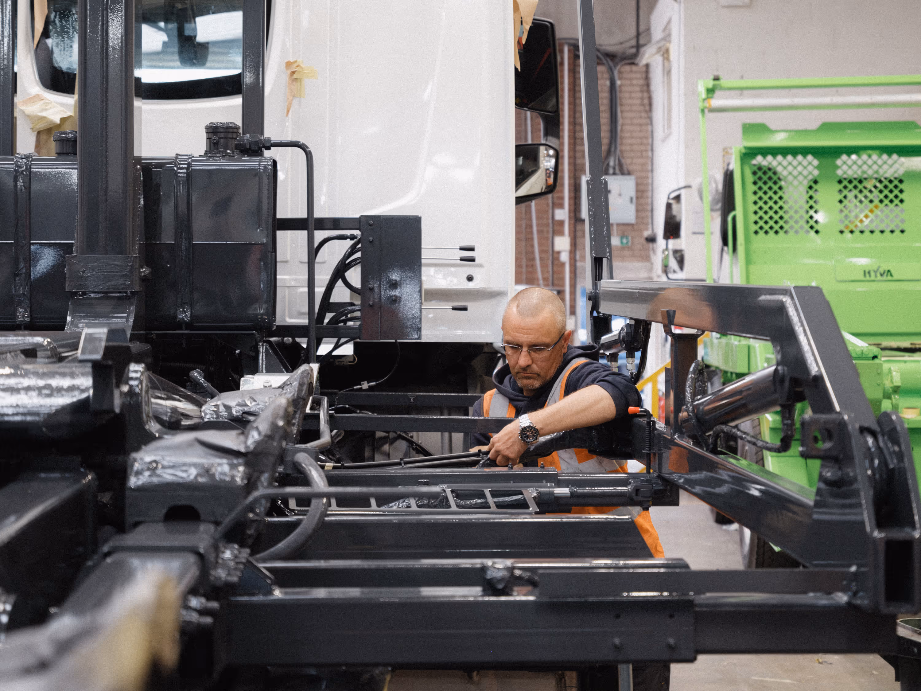 WCC staff member reassembling a truck chassis after respray.