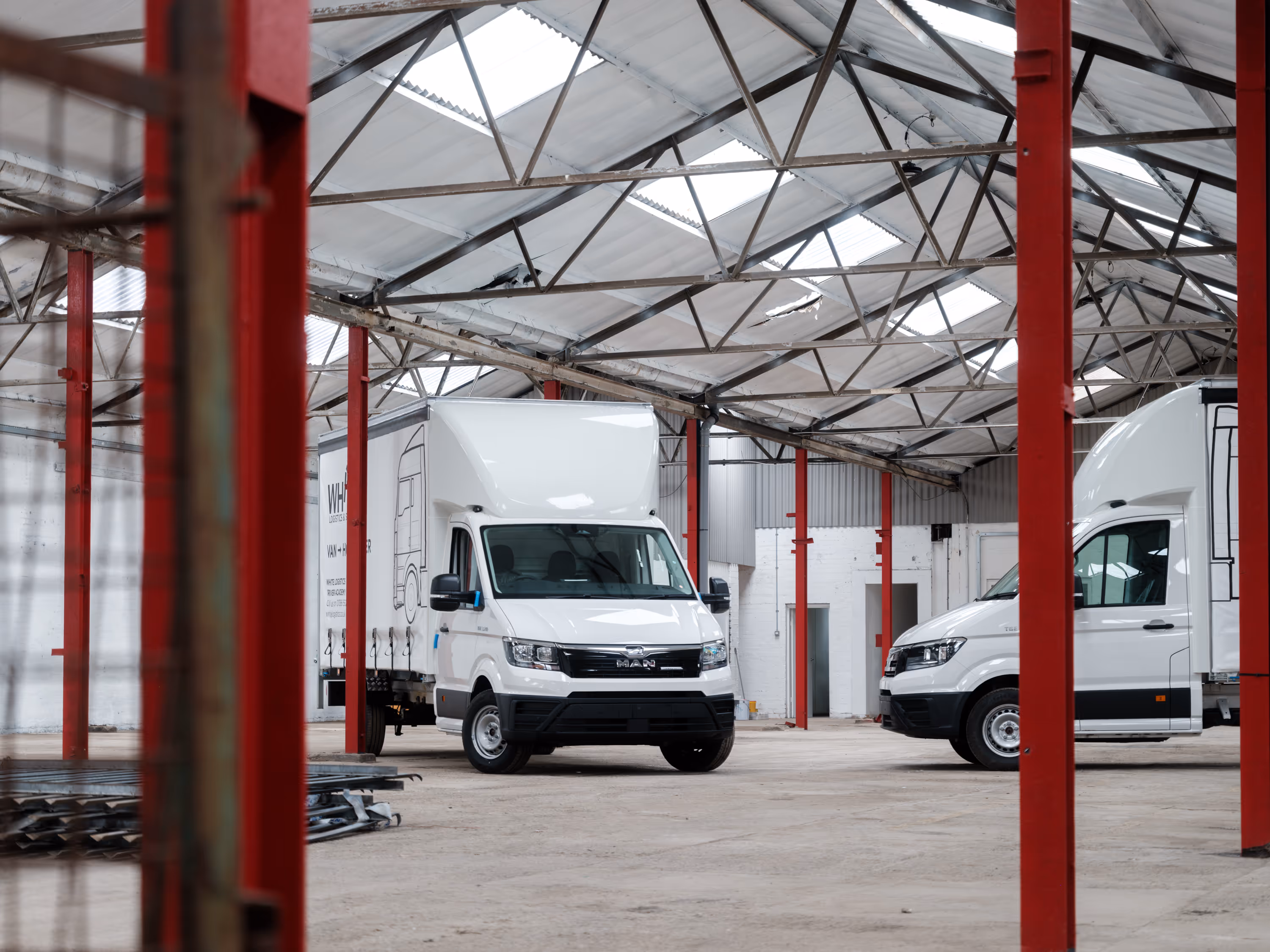 Two new White Logistics and Storage MAN TGE 3.5 tonne trucks with bodybuild work completed by WCC.