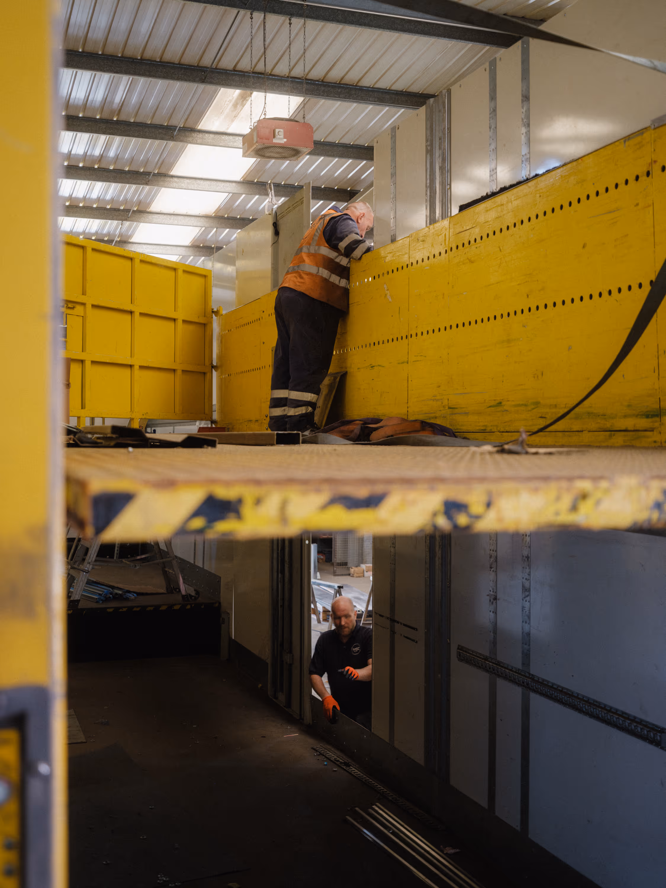 WCC staff repairing a double deck DHL trailer.