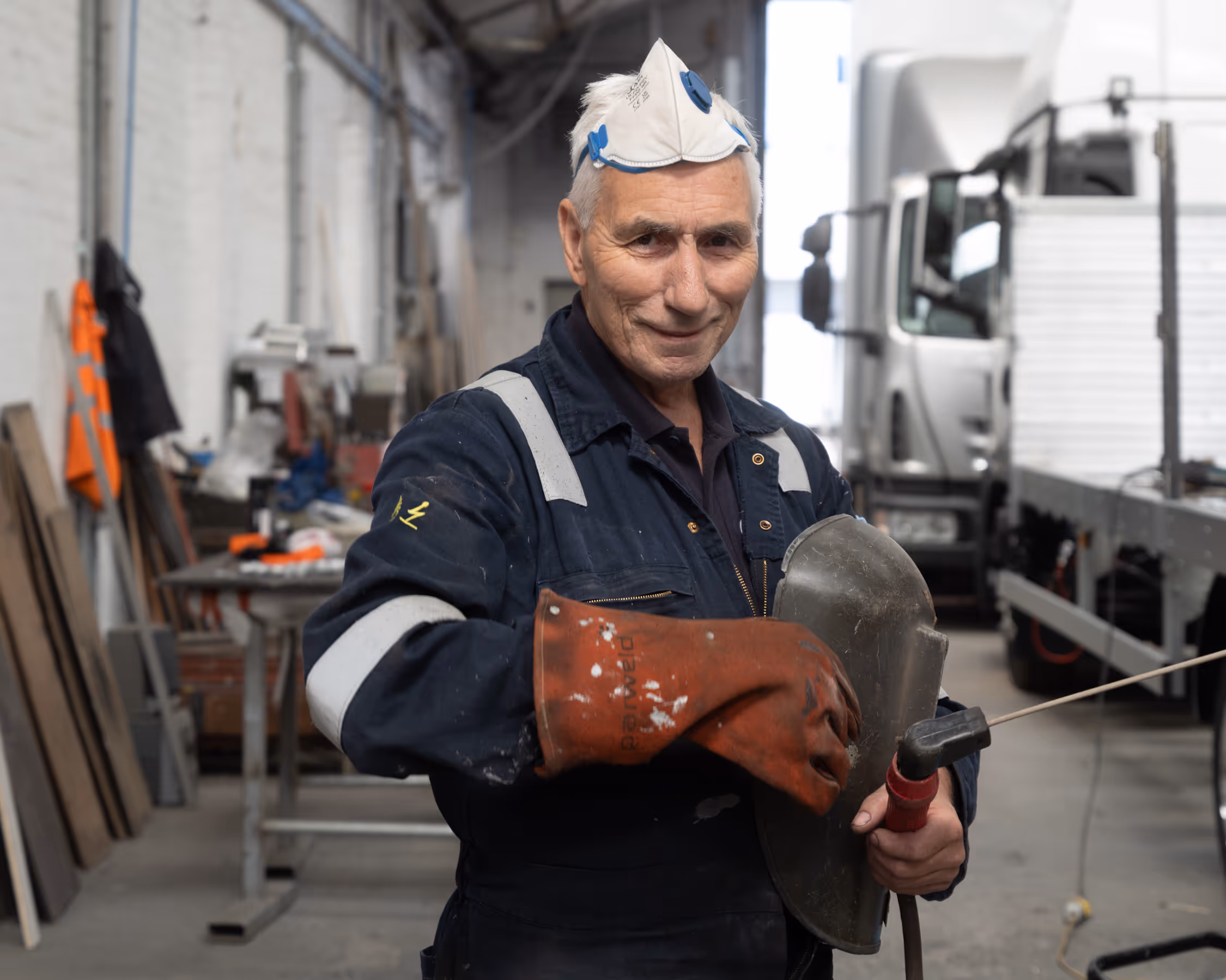 A WCC worker in welding gear.
