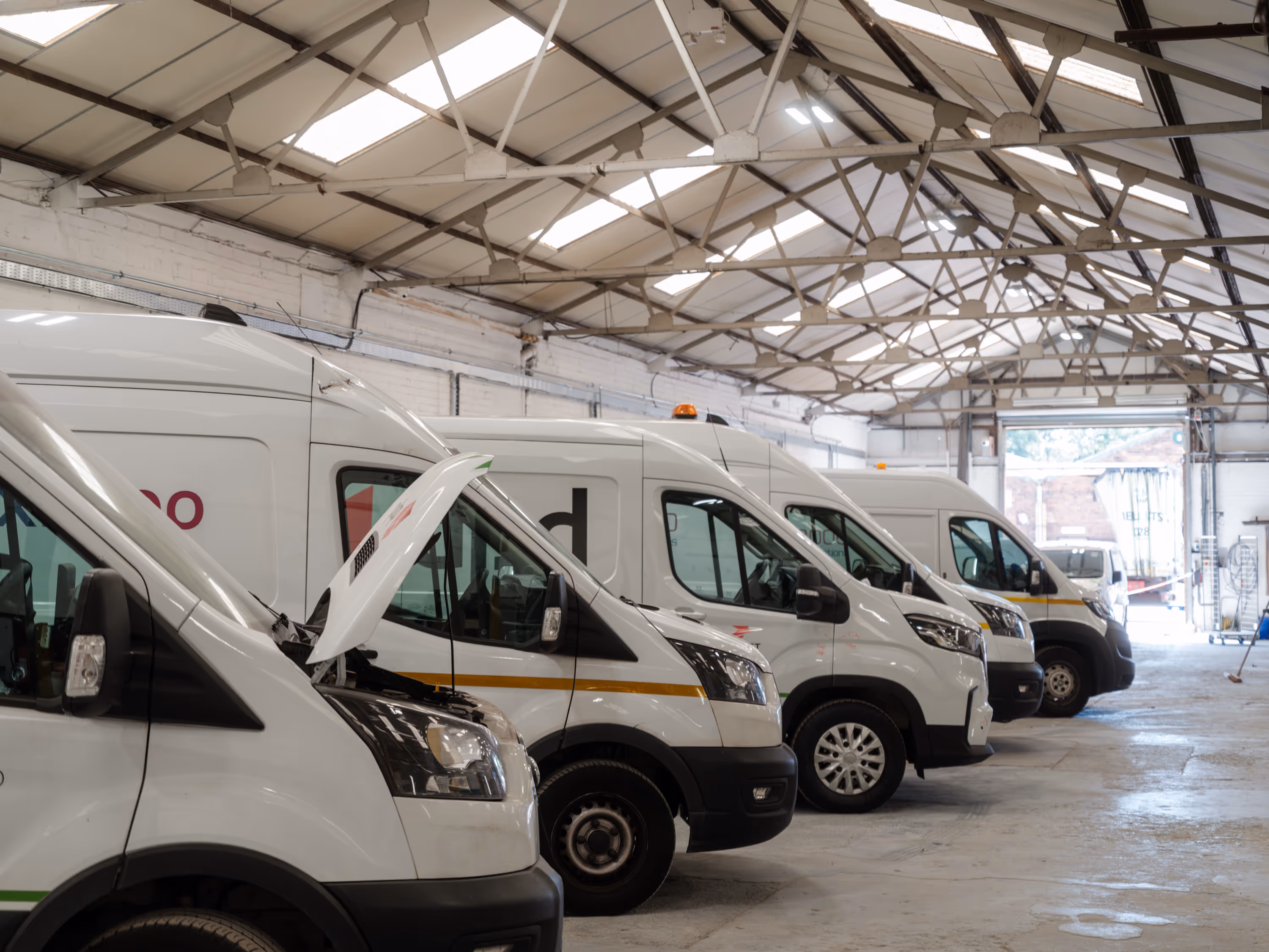 four vans needing panel needing repairs in the WCC workshop. 