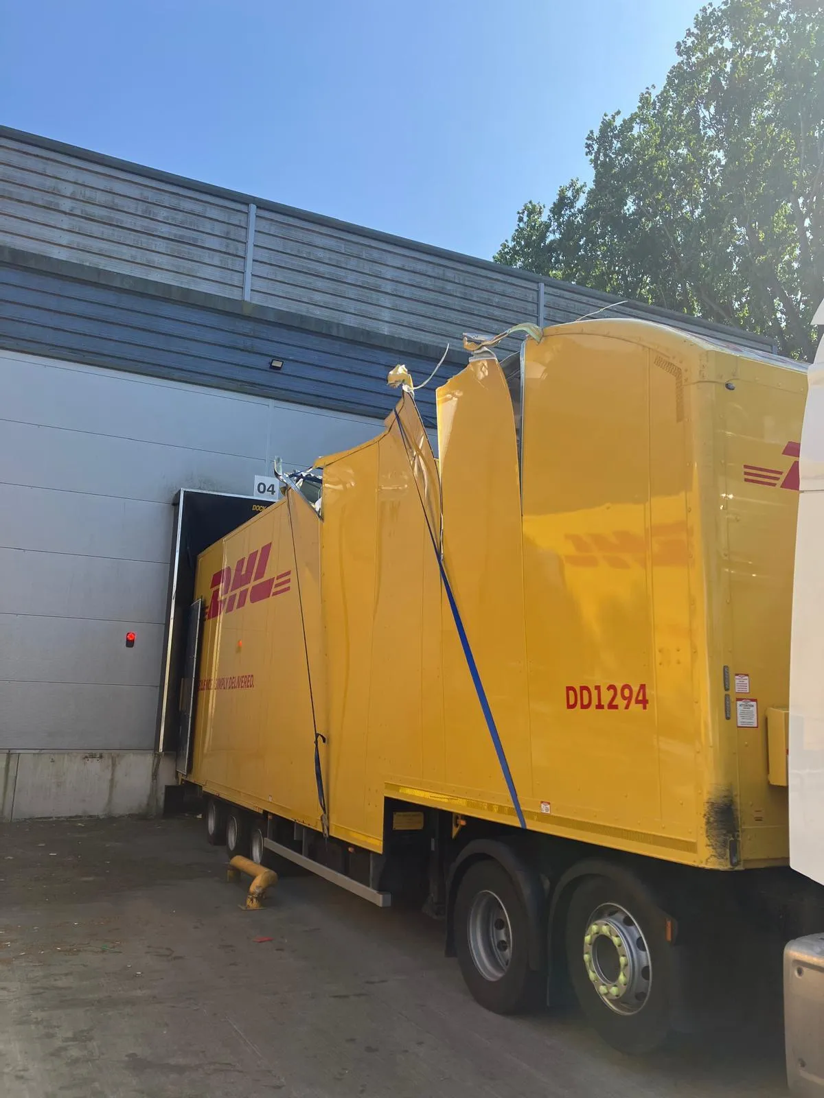 A damaged DHL double deck trailer.