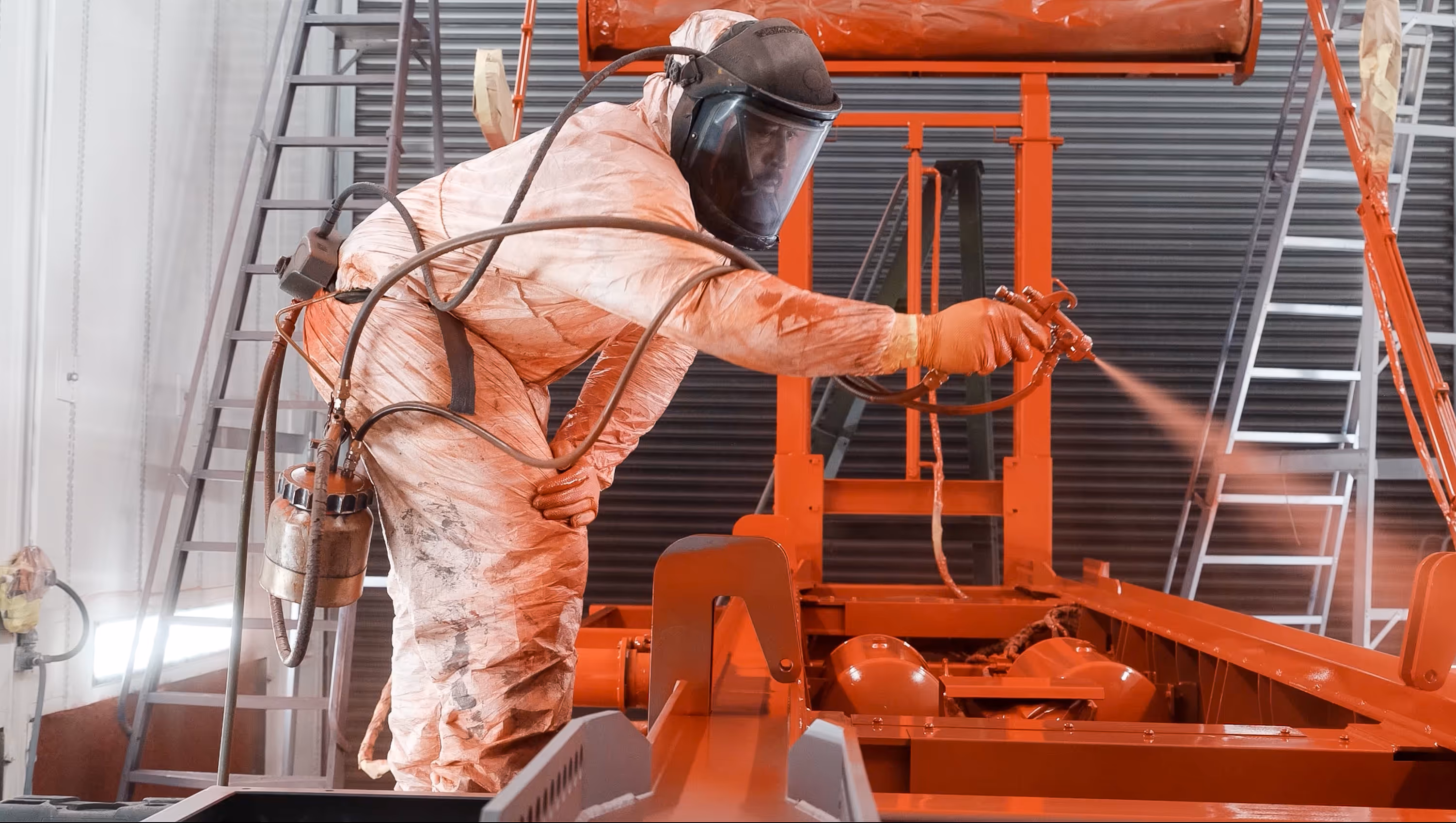 WCC worker spraying a truck chassis red.