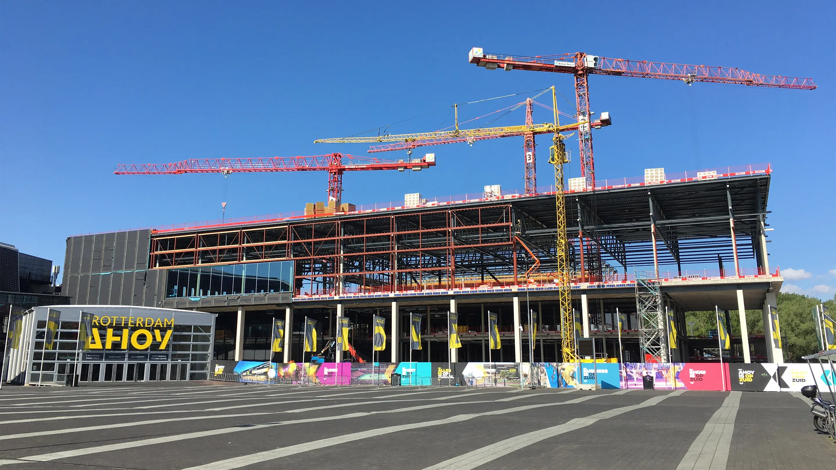 View of the Rotterdam Ahoy construction site with cranes and building structure where Merford acoustic solutions are applied.