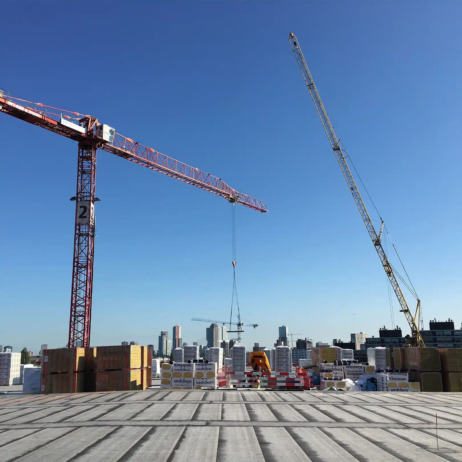 Construction at the roof of Rotterdam Ahoy, with skyline in the background.