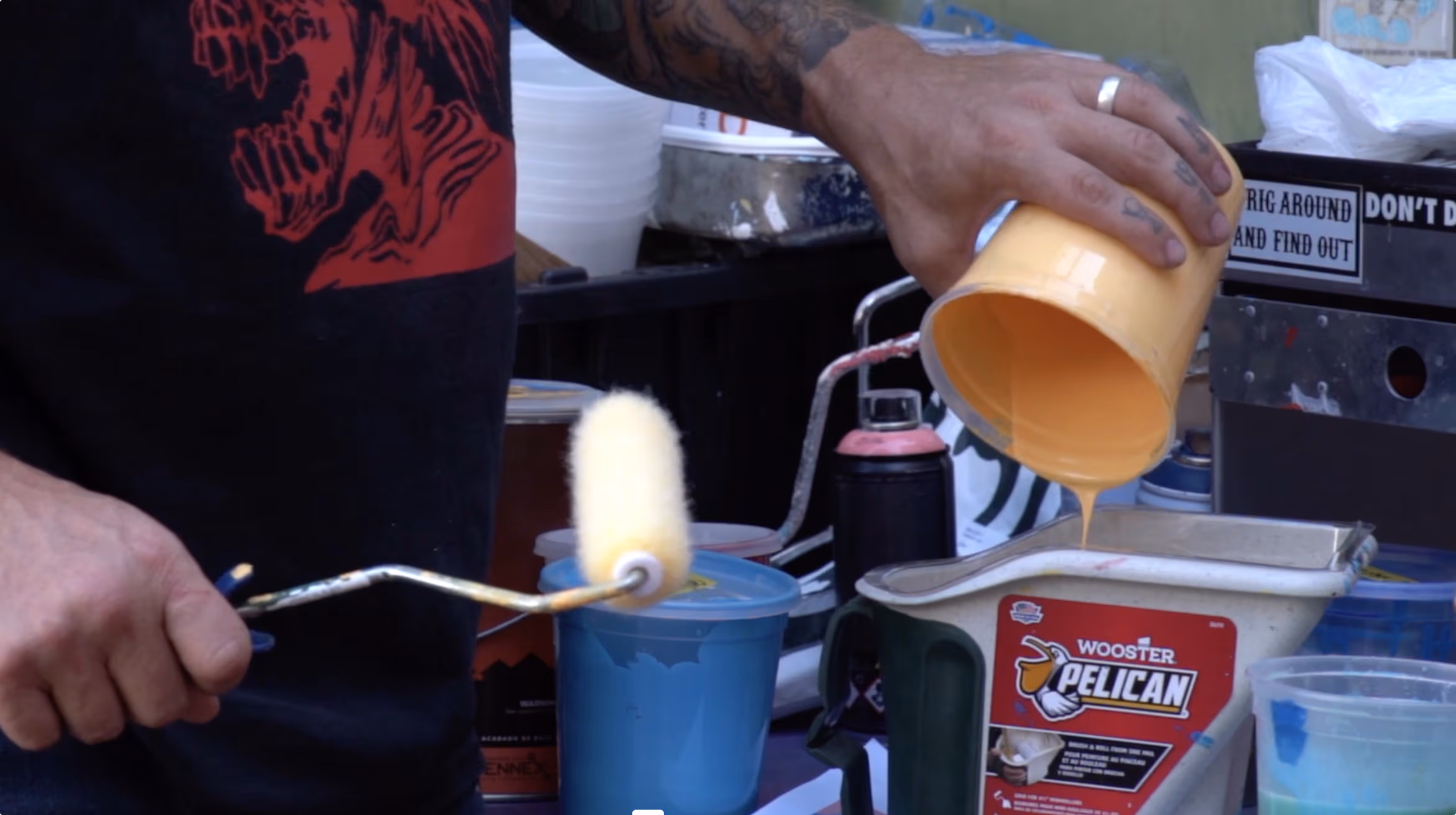 A man preparing a pastel orange paint in his workshop
