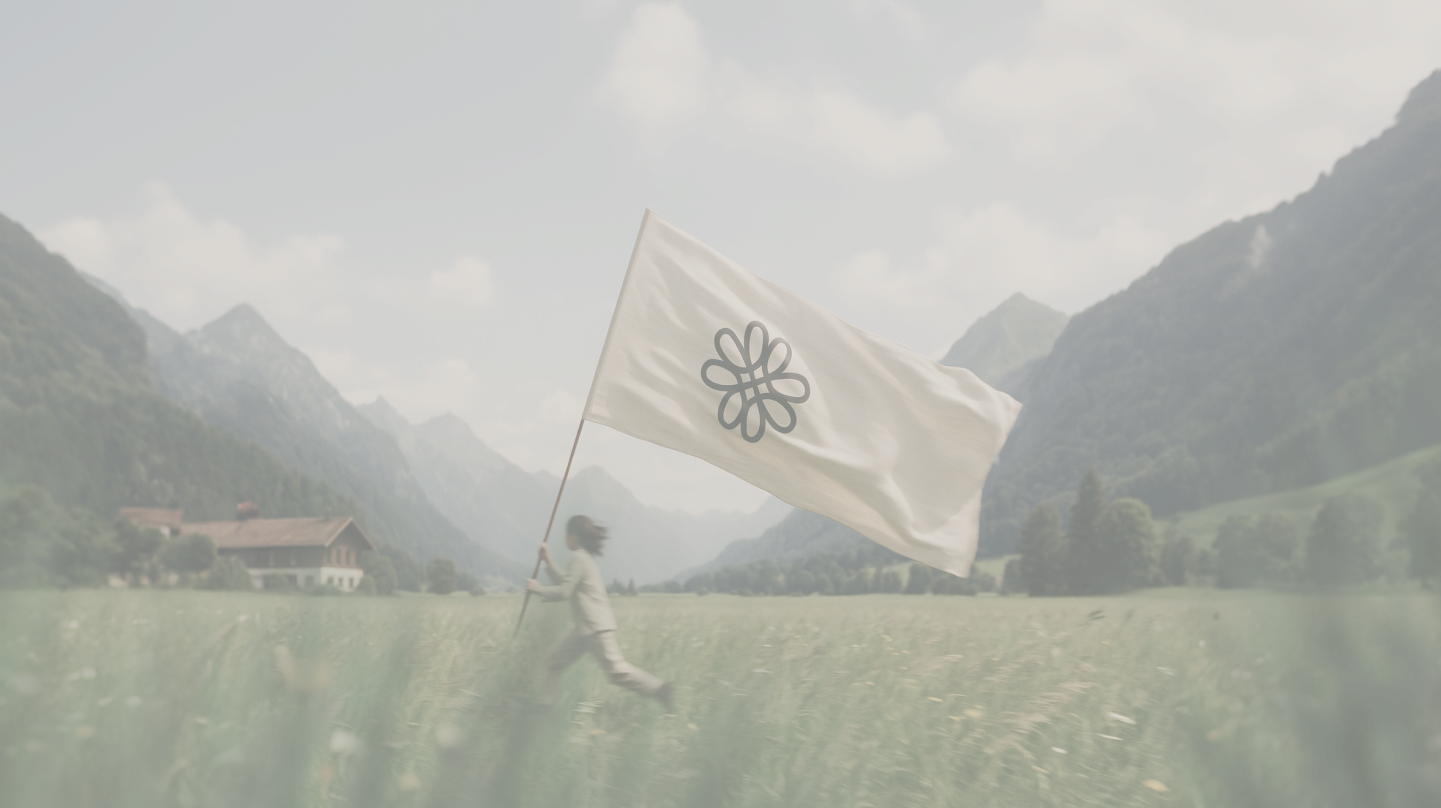 Person running through grassy field holding a large white flag with a black abstract flower symbol, with mountains and a farmhouse in the background.