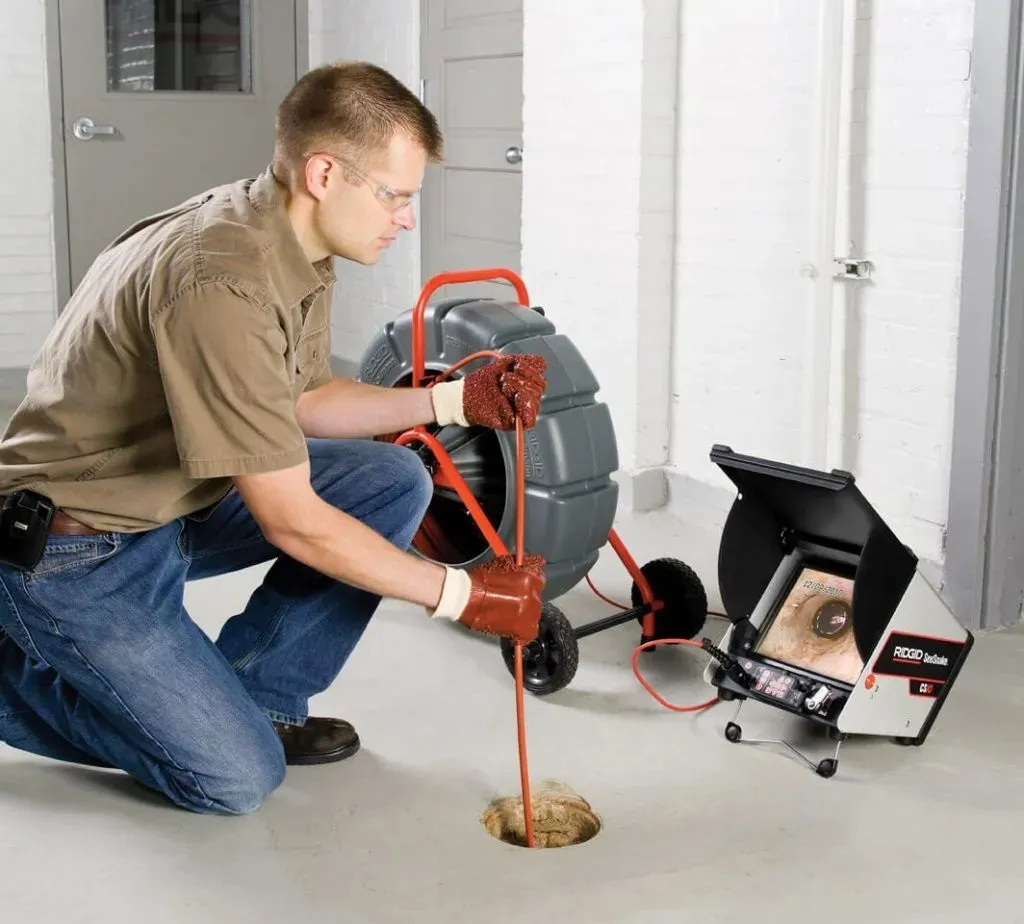 Plumber uses camera for sewer inspection.