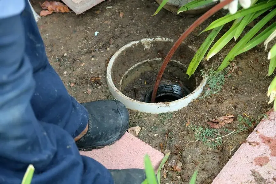 Pipe entering an outdoor drain.