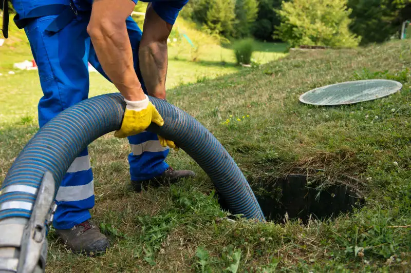 Man cleaning out septic tank.