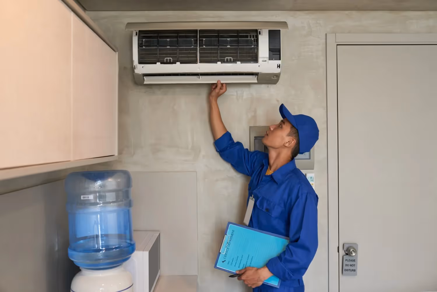 Technician checking indoor mini-split air conditioner.