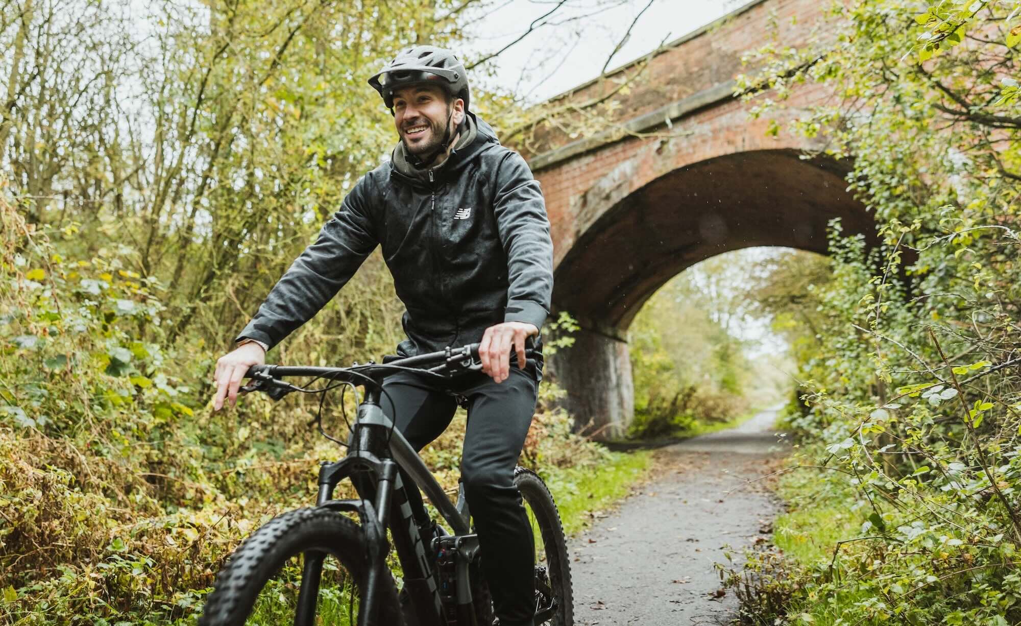 man cycling on woodland trail