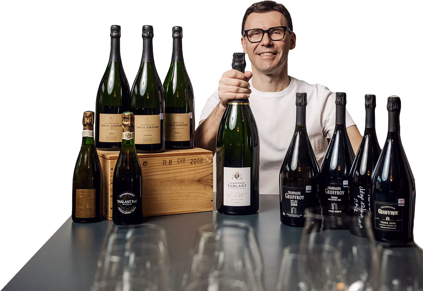 Aigars Nords sitting at the table with multiple bottles of champagne