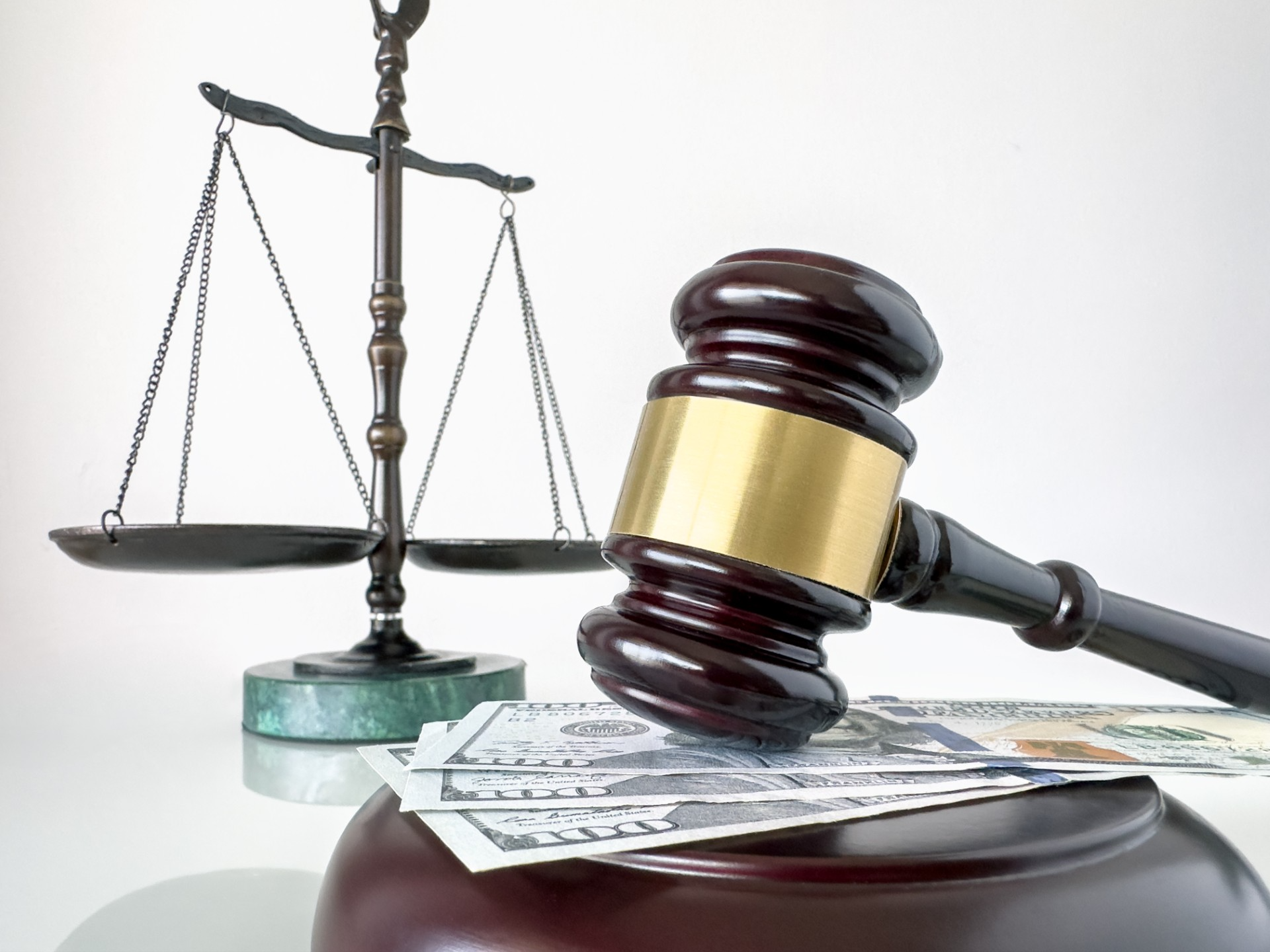 Gavel, scales of justice, and dollar bills representing bail bond payment options
