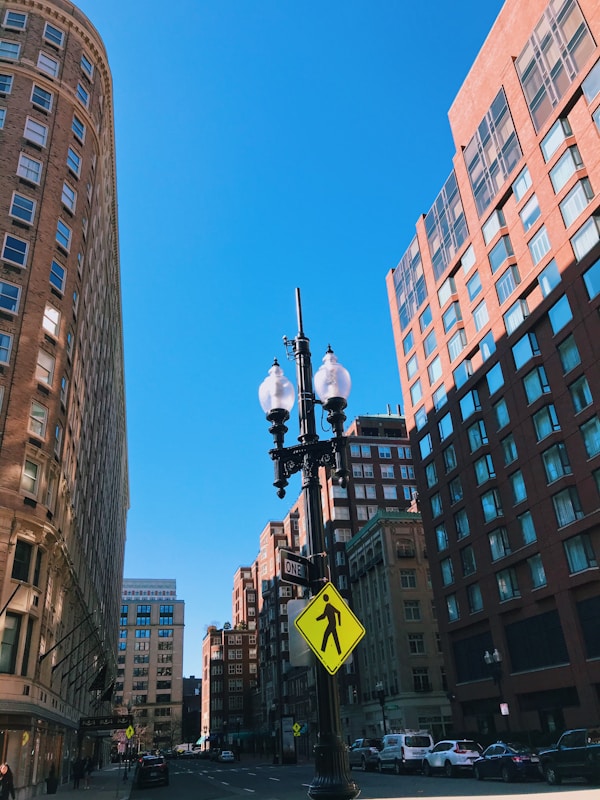 black street light near high rise buildings during daytime