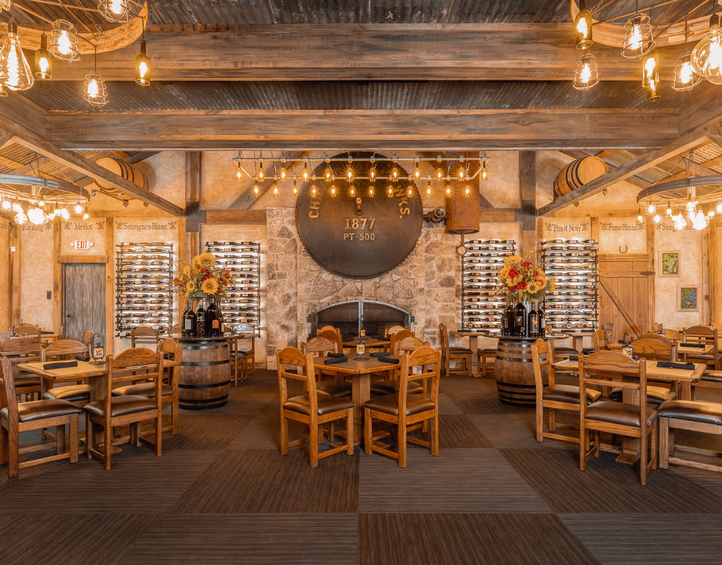 Rustic winery tasting room with wooden decor, wine racks, and vintage lighting