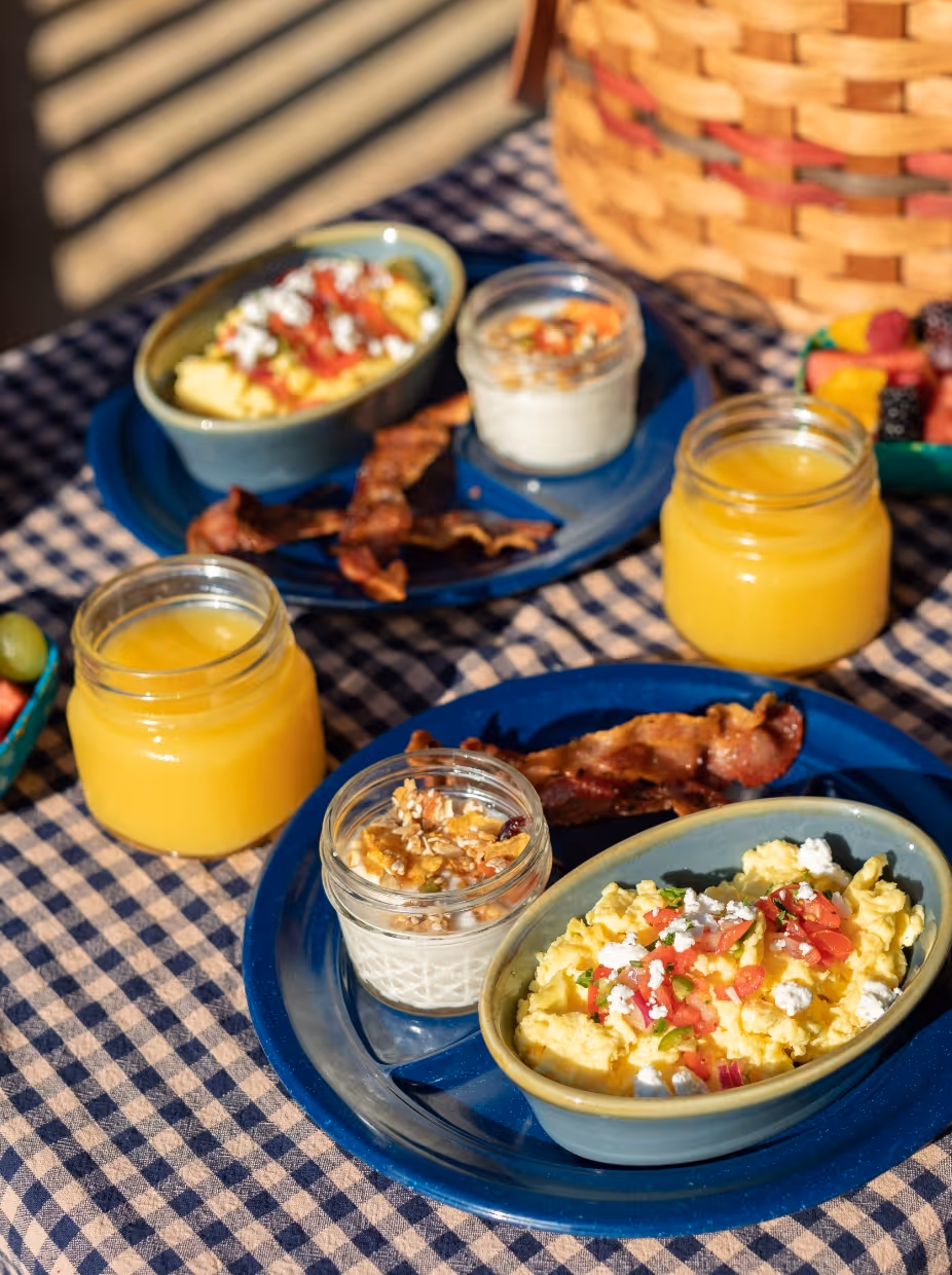 Homemade breakfast spread with scrambled eggs, bacon, orange juice and yogurt parfait served at a Fredericksburg, TX Bed & Breakfast