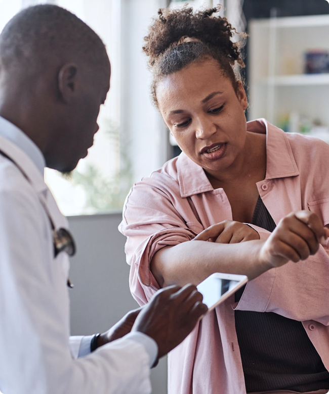 SmartCare Rx Pharmacy doctor consulting with a patient about skin health and dermatological concerns in clinic.