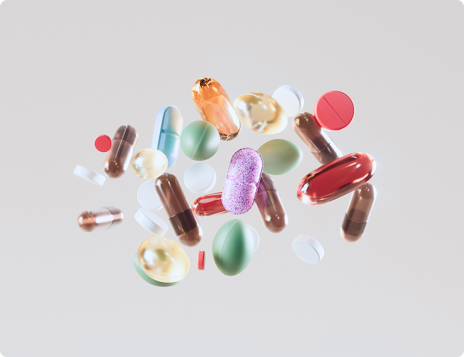Variety of colorful prescription pills and capsules floating against a neutral background, illustrating compounded medications.