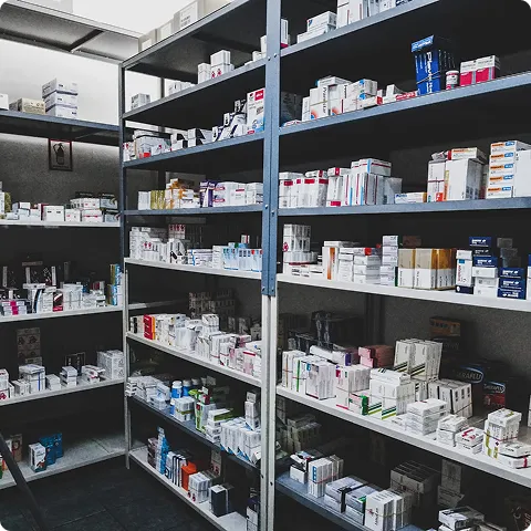 SmartCare Rx Pharmacy well-stocked pharmacy shelves organized with a wide variety of prescription medications and pharmaceutical products, illustrating professional inventory management