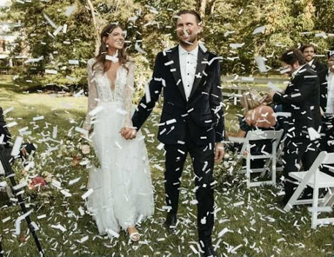 Couple walking through confetti after being married