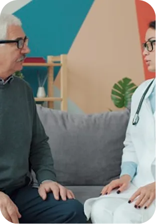 Doctor with stethoscope consulting with patient in colorful modern office.
