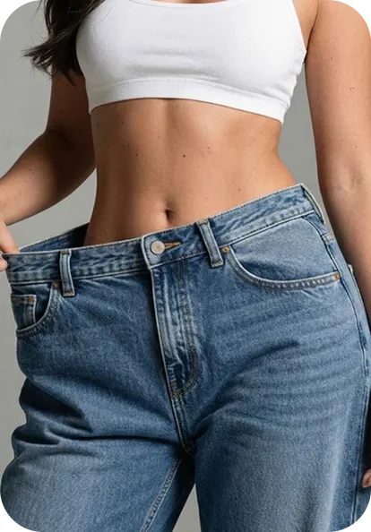 Woman wearing white crop top and oversized blue denim jeans showcasing fit