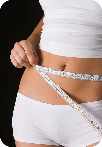 Woman measuring waist with tape measure for body tracking and fitness assessment