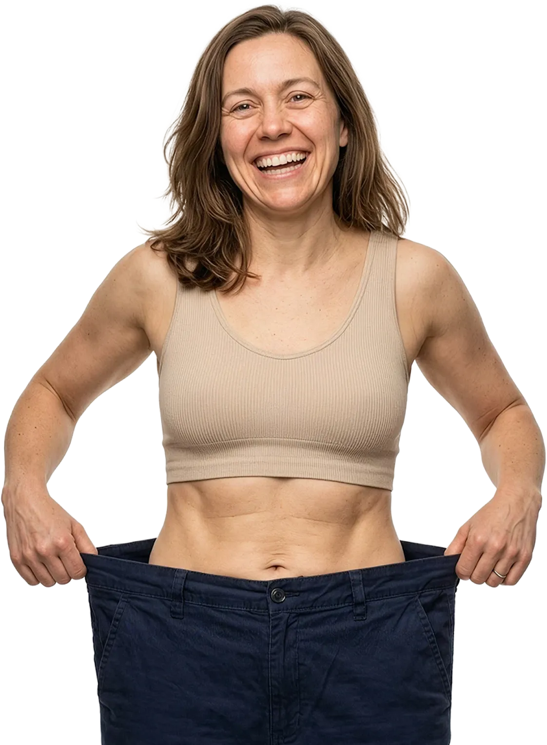Smiling woman showing oversized jeans, demonstrating significant weight loss success