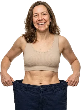 Woman smiling, holding oversized pants to show weight loss success