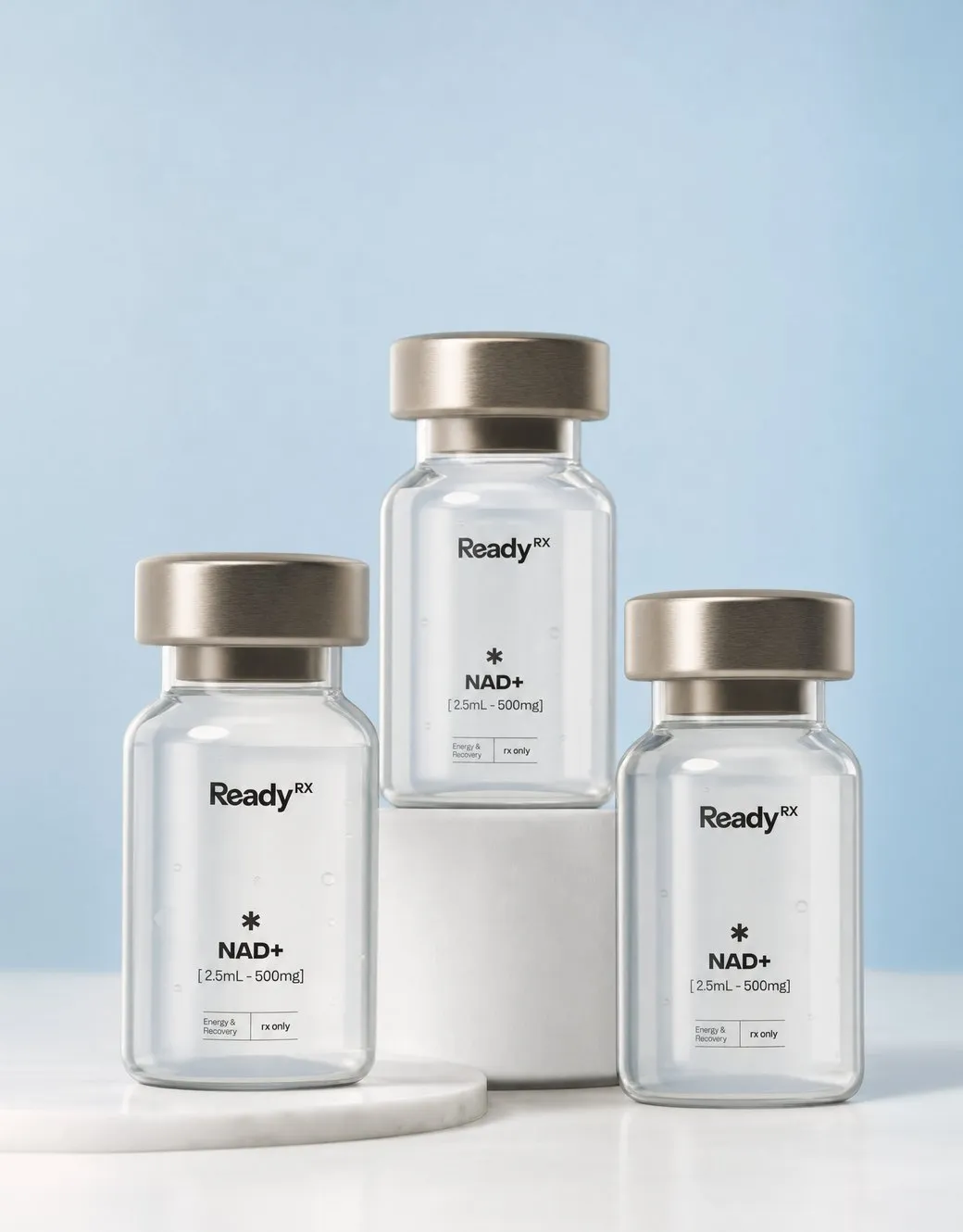 Three ReadyRx NAD+ supplement bottles with metal caps on blue background